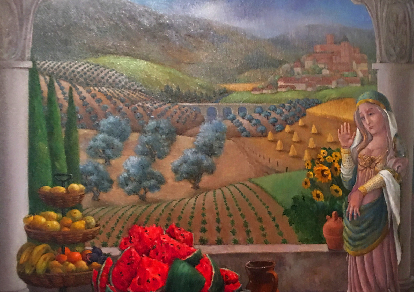 Painting by Louise Craven Hourrigan: Madonna figurine, bowl of sliced watermelon, and rolling hills with orchards.