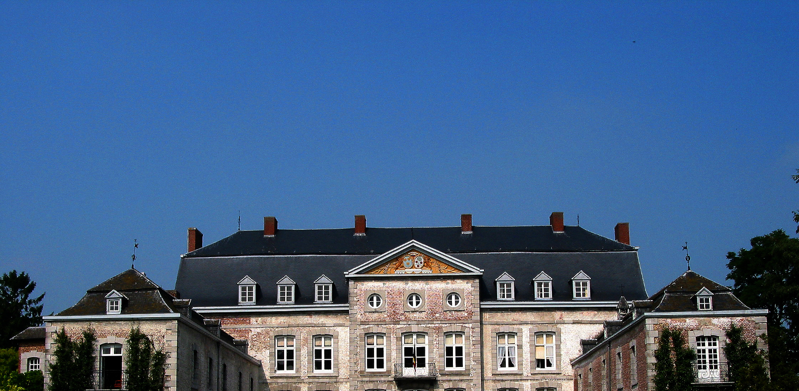 Stately mansion against a dark blue sky